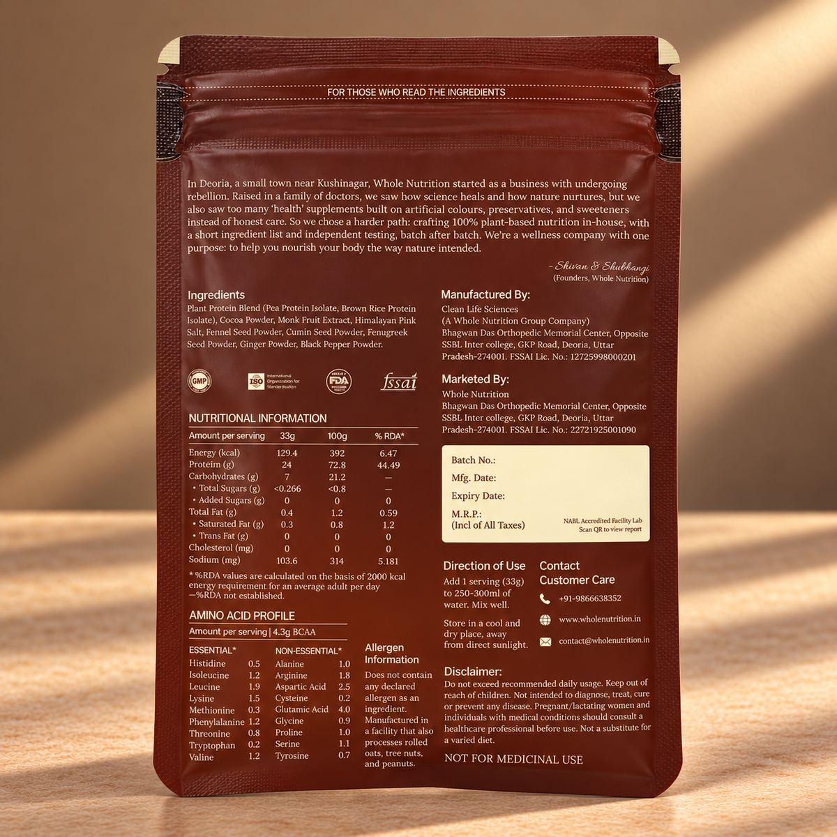 Back view of a dark brown resealable pouch of Whole Nutrition brand protein powder, showing detailed text, ingredients, nutritional information, and branding on a wooden surface.
