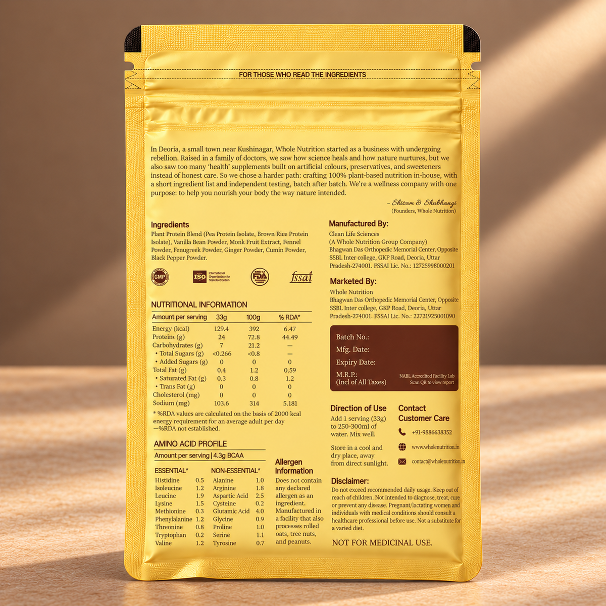 Back of a gold pouch of Whole Nutrition 'Inherit, Love, Give' protein powder, featuring detailed text, ingredients, nutrition facts, and contact information on a warm brown textured background.