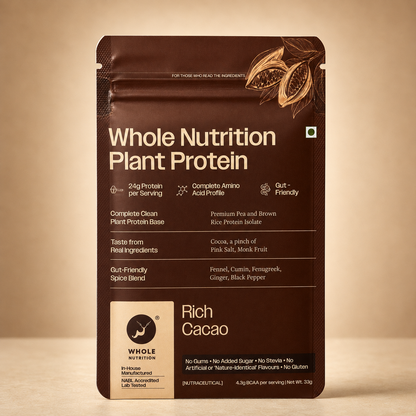 A stand-up pouch of Whole Nutrition Plant Protein powder, Rich Cacao flavor, in dark brown packaging with cream text and illustrations, photographed against a warm beige gradient background.