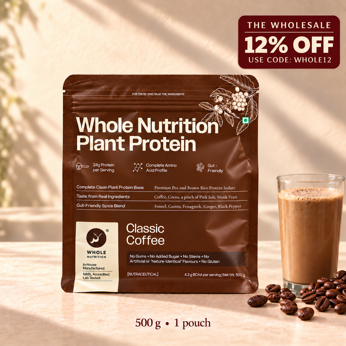A 500 g pouch of Whole Nutrition Plant Protein Classic Coffee in a brown stand-up package, shown on a warm beige surface with coffee beans and a glass of coffee beside it. A promotional badge in the top right reads 'The Wholesale 12% Off Use Code: Whole12'.